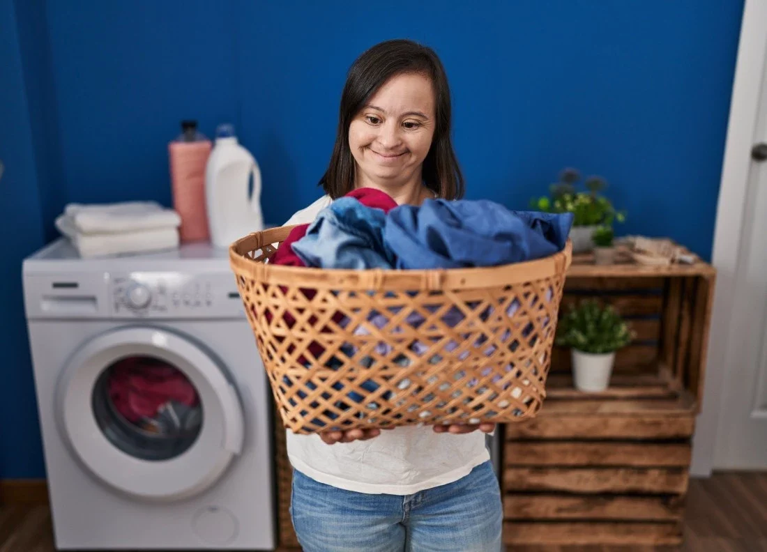 Young girl with down syndrome doing laundry