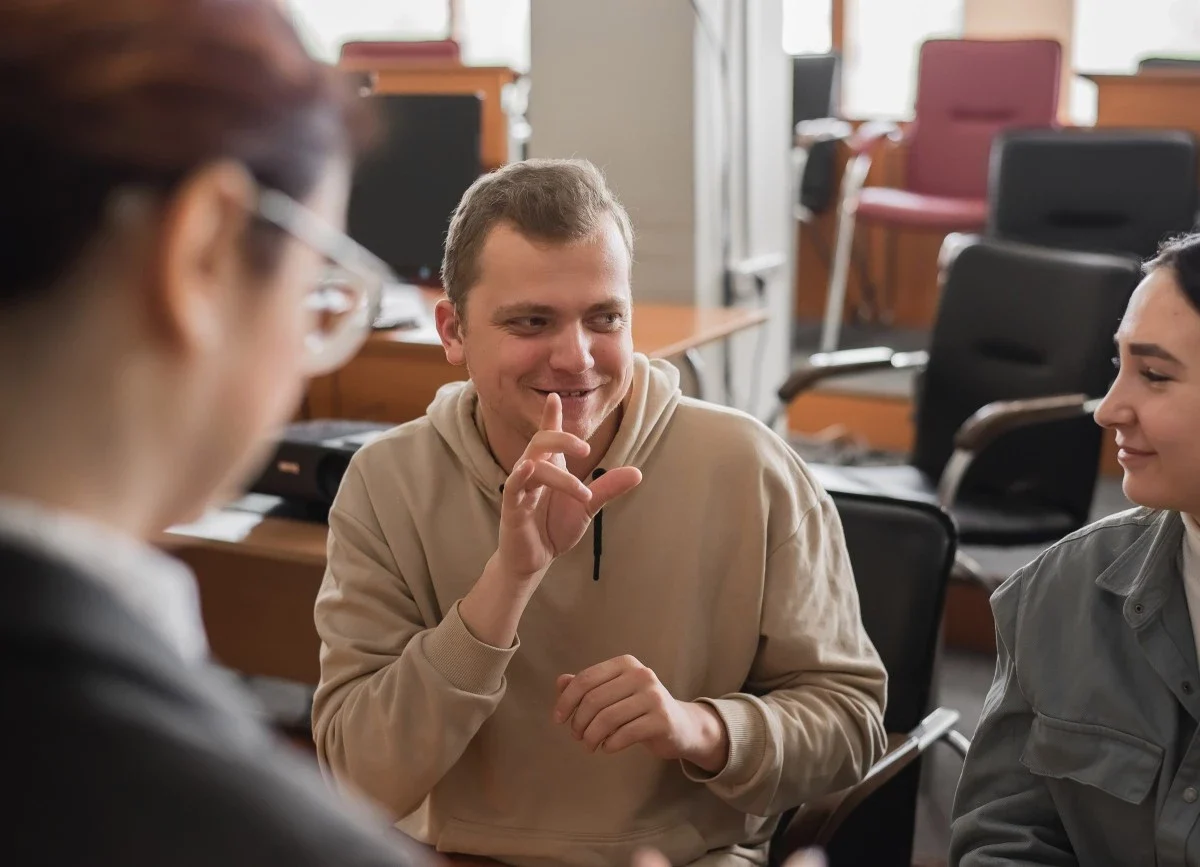 Guy with down syndrome talking with friends