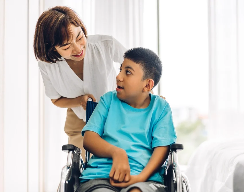 nurse with young disabled boy on wheelchair