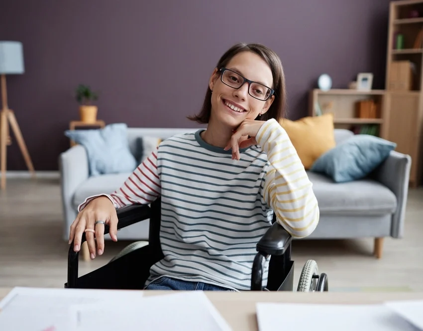 down syndrome woman sitting on wheelchair looking at camera