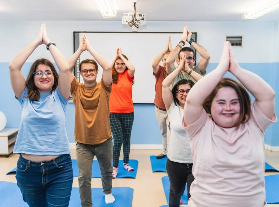 group of friends with different disabilities doing yoga together