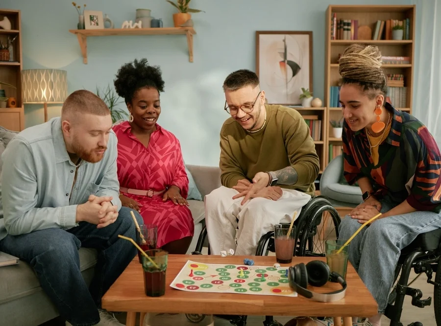 group of friends on wheel chair playing chess
